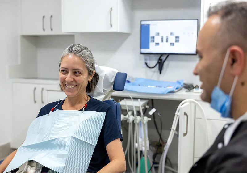 patient smiling during her first visit to Farsio Dental Specialty Group