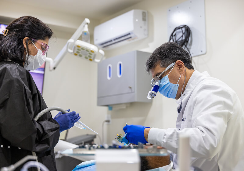 Dr. Fariborz Farsio performing oral surgery