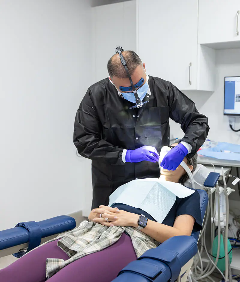 Dr. Farsio providing dental care for a patient