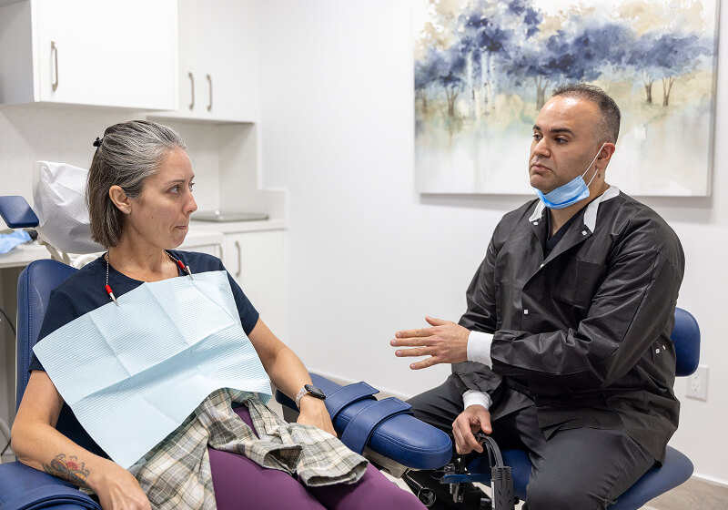 Dr. Farsio discussing periodontal treatment with a patient