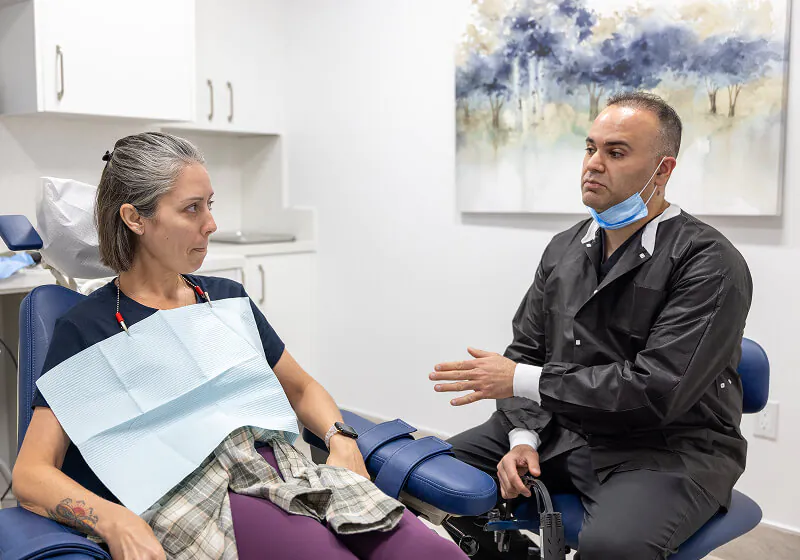 Dr. Farsio discussing periodontal treatment with a patient